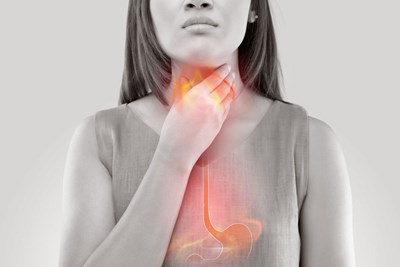 Image of a girl struggling with indigestion that hasn't learned the underlying causes of acid reflux and indigestion.