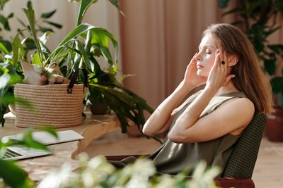 A person with a headache to discuss the Unsuspected Root Causes of Headaches and Finding the Root Cause of Migraines. 