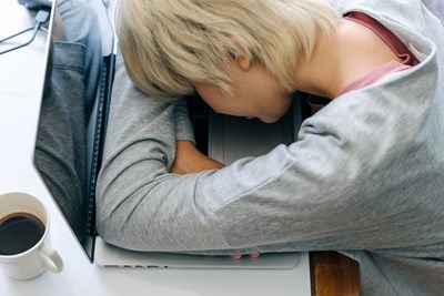 A person with low energy, who is falling asleep working and doesn't know about natural energy boosters. 
